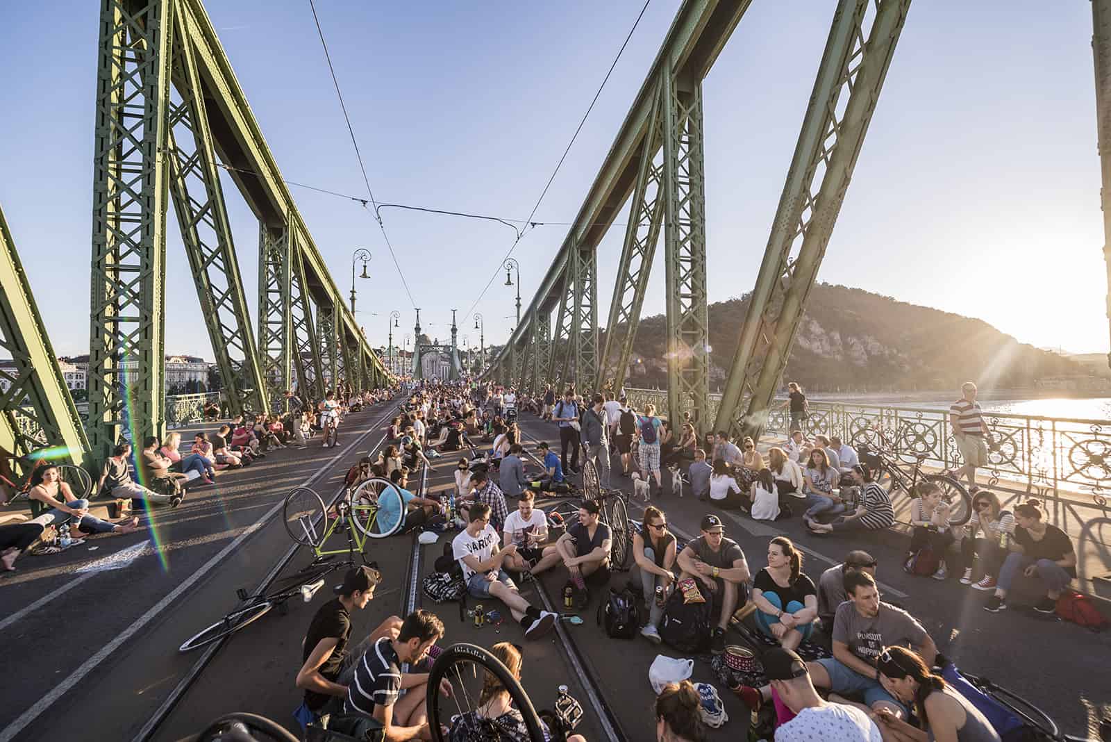 Crowds relaxing on the closed Liberty Bridge in Budapest during summer
