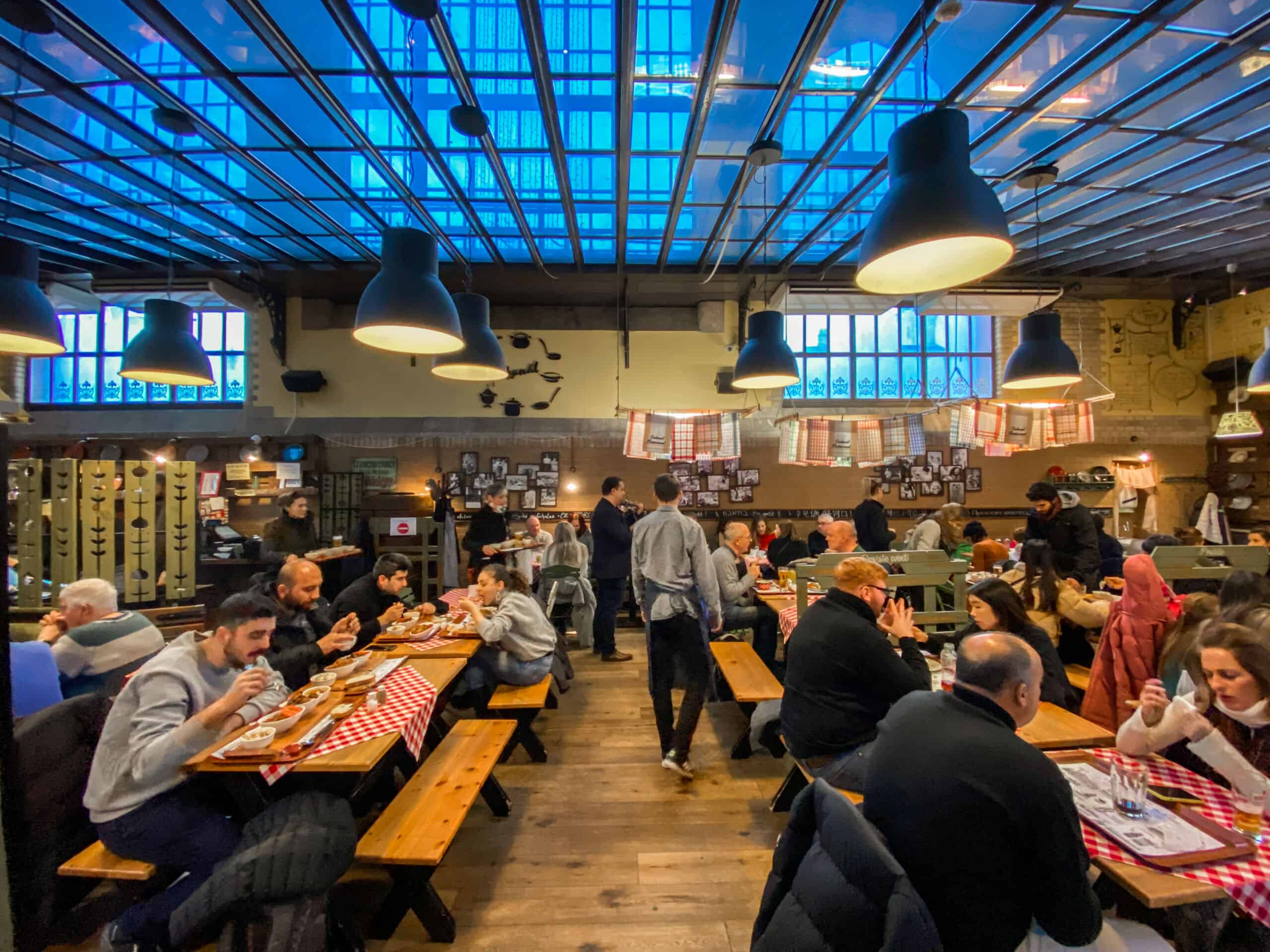 A bustling local Hungarian restaurant filled with people eating