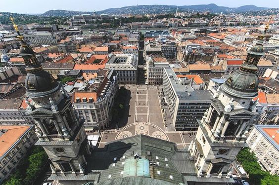 A hot, freshly baked, sugar-coated chimney cake held ready to eat