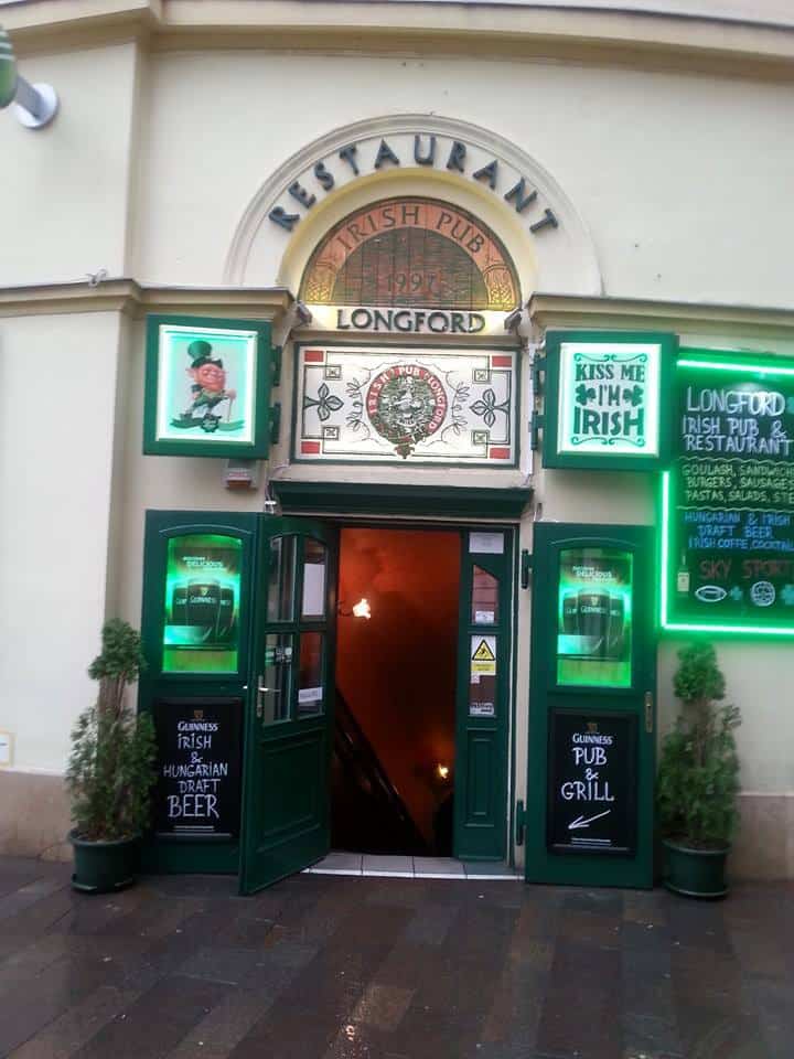 The green wooden exterior facade of the Longford Irish Pub
