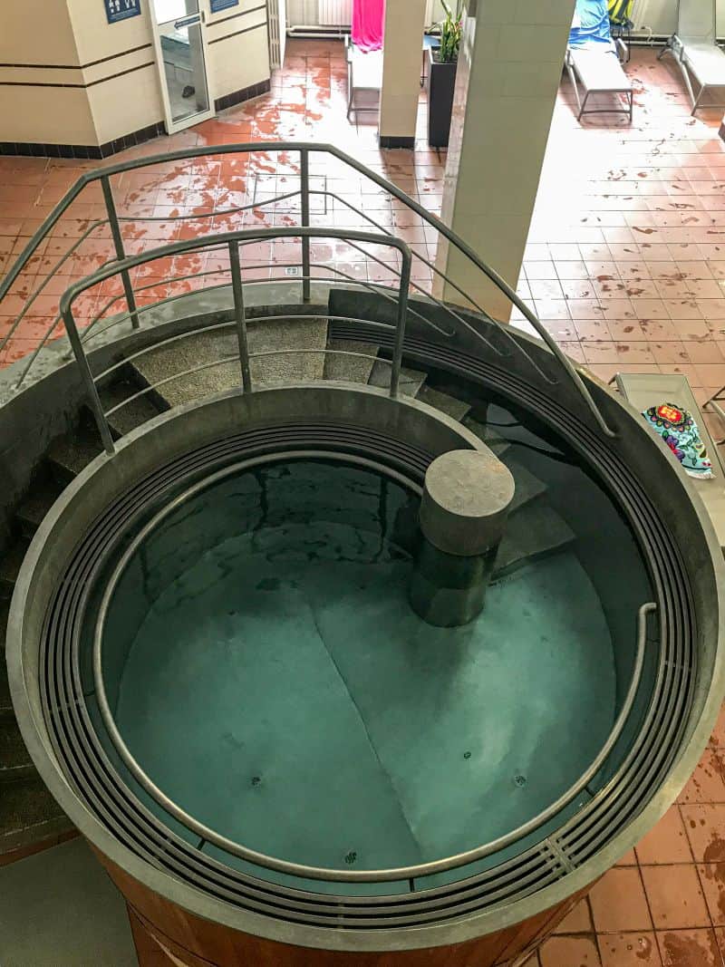 Thick therapeutic steam powerfully rising from the famously hot medicinal indoor thermal water