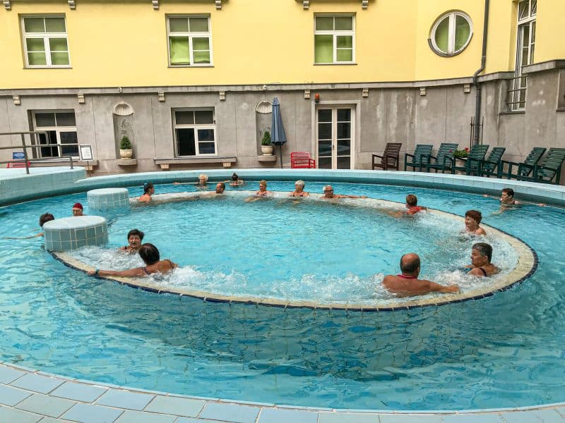 Guests deeply enjoying the rapidly moving hot water channels inside the Lukacs outdoor adventure pool