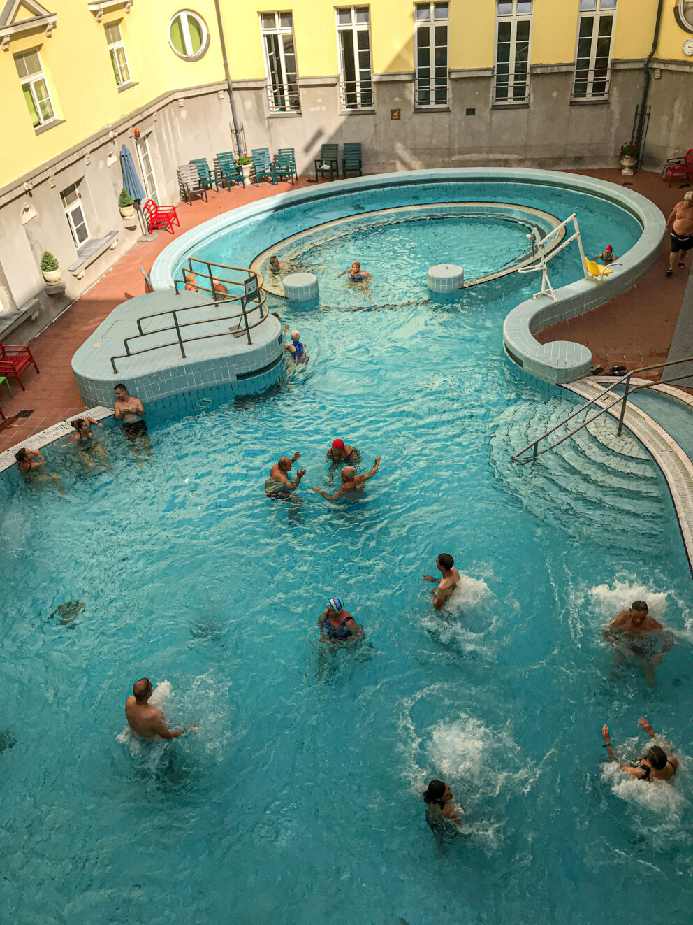A clear overhead view of the deeply curved fully outdoor active adventure pool.