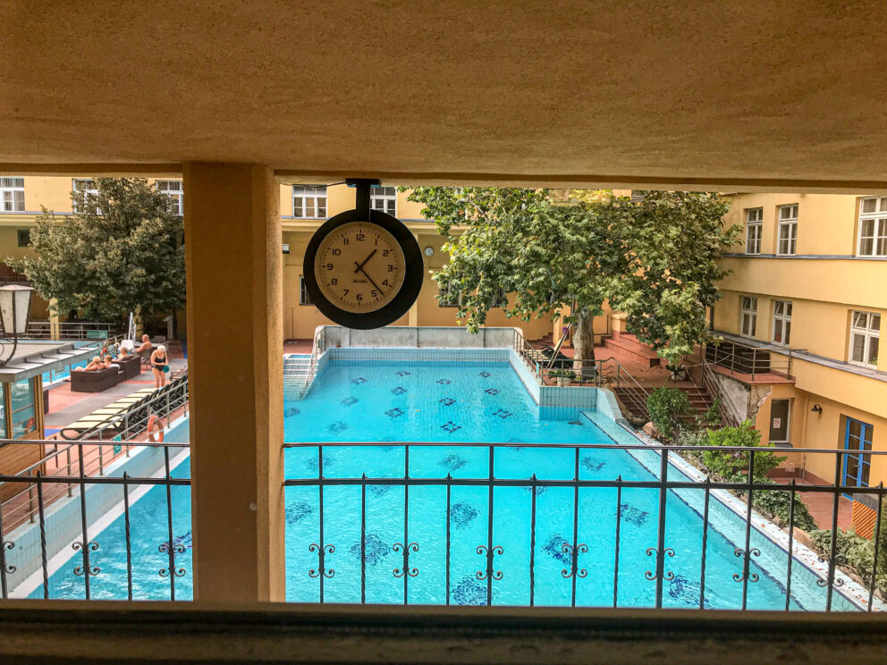 The fast flowing artificial waterfall vigorously pouring directly into the outdoor pool