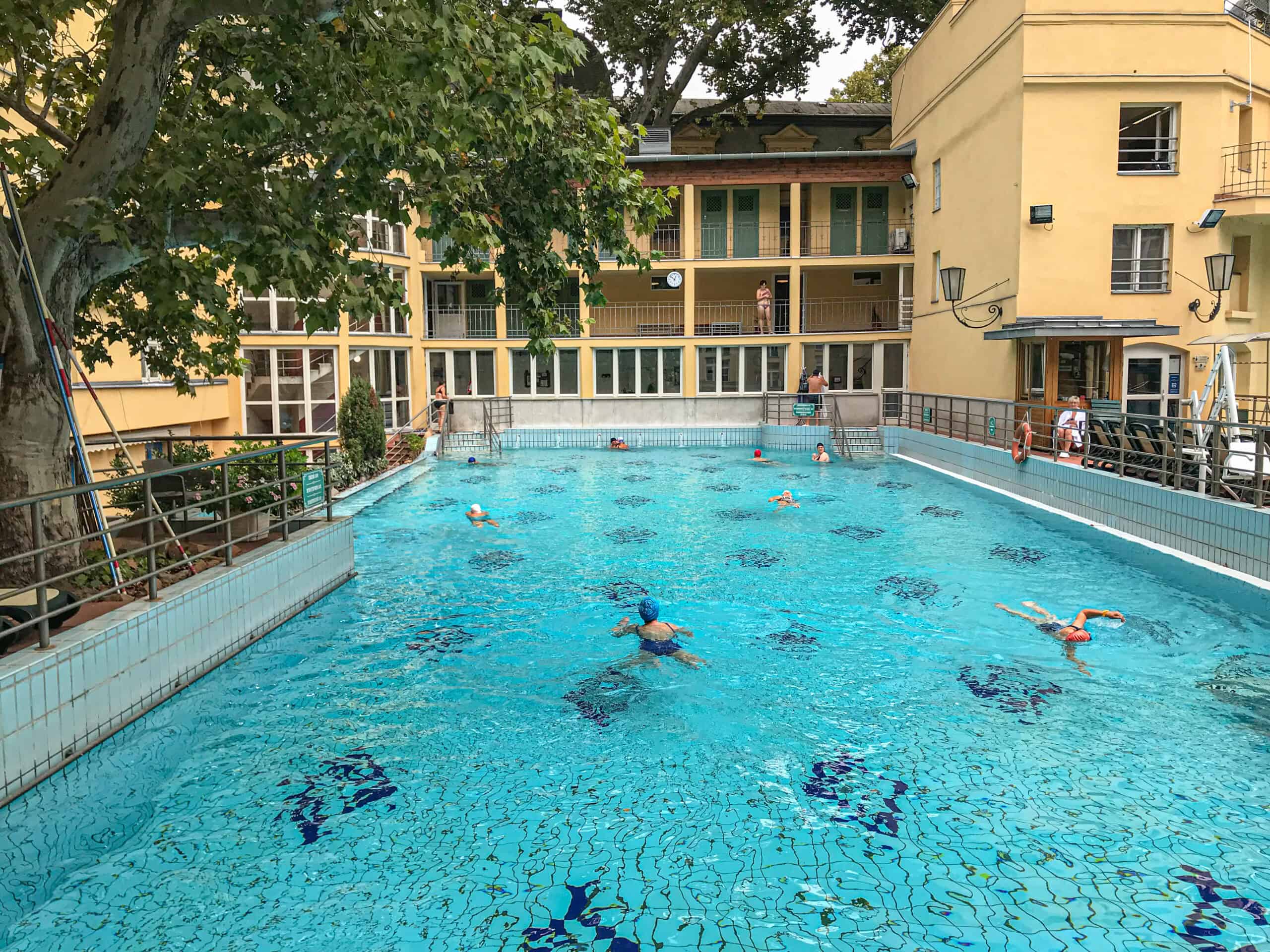 The massive, beautifully tiled outdoor lap swimming pool located securely within Lukacs Bath