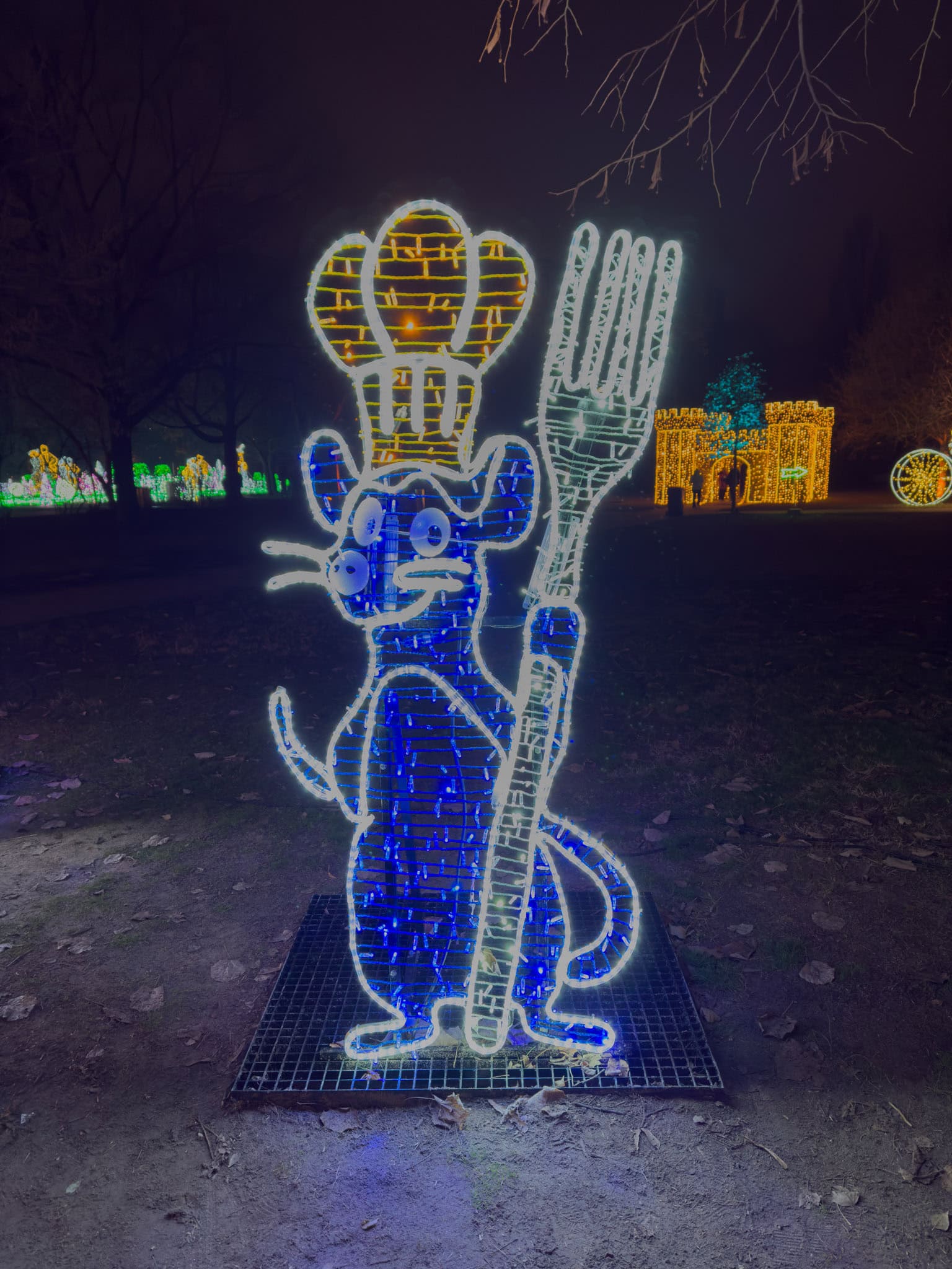 A cartoonish rodent uniquely wearing a glowing white chef hat holding a pan