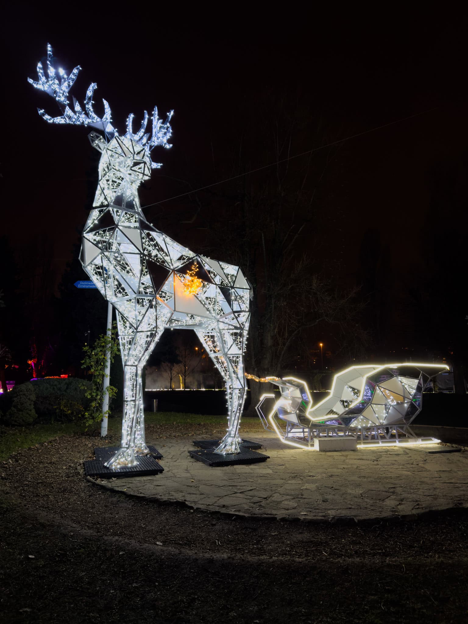 A glowing magical sleigh pulled by shining LED reindeer serving as a photo point