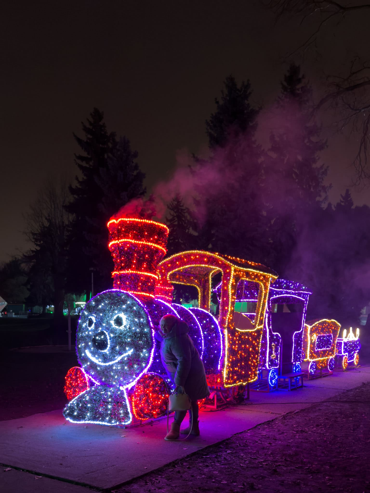A large historically accurate glowing steam locomotive safely parked on the grass