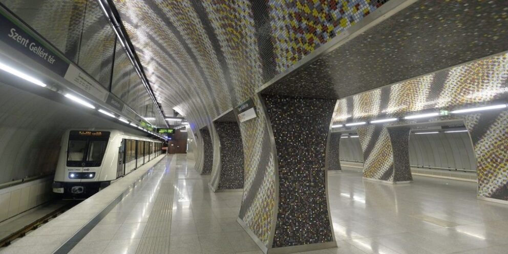 The automated green M4 metro train stopping at the beautifully designed Szent Gellért tér underground station