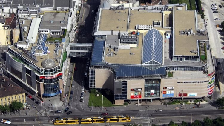 The massive highly distinct curved modern glass and metal facade of the enormous shopping complex