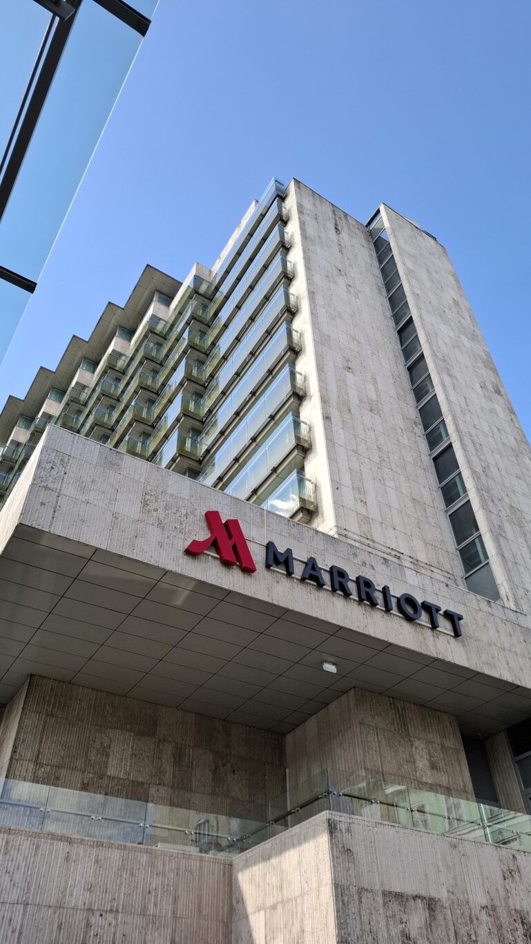 A comfortable dining lounge area beautifully lit with modern fixtures and spacious comfortable seating perfectly arranged securely beside panoramic windows