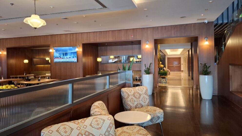 A modern fully equipped premium fitness center cleanly showcasing state-of-the-art exercise machines safely facing panoramic windows