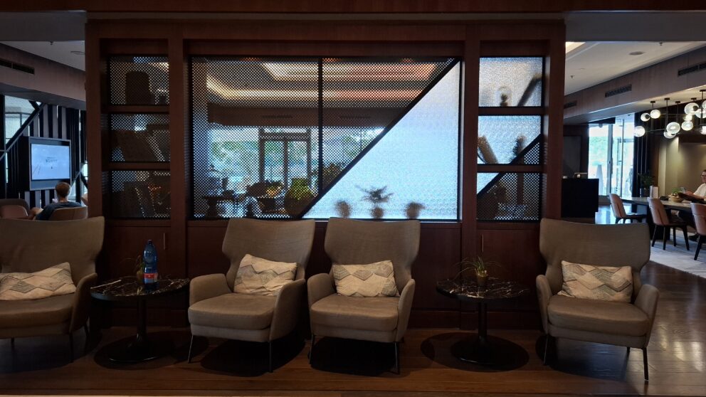 A lively wide view capturing the elegant high-end rooftop cocktail bar situated atop the hotel