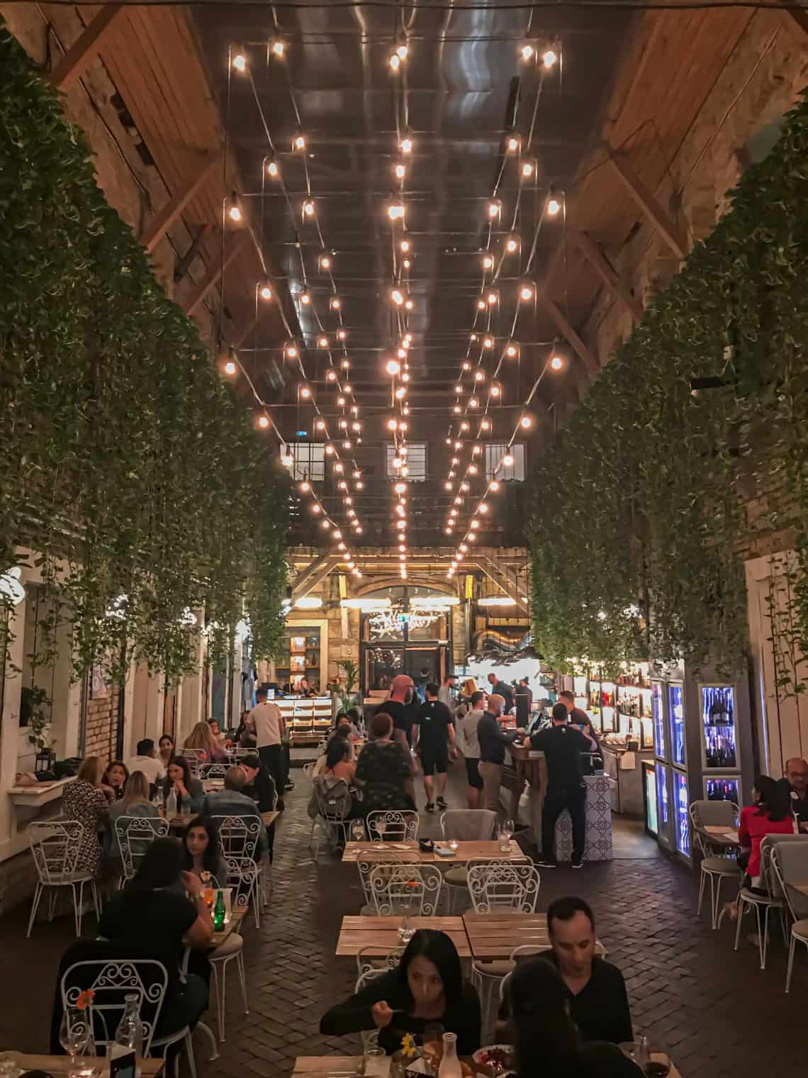 A vertical shot showcasing lush green vines draping beautifully down the tall brick walls