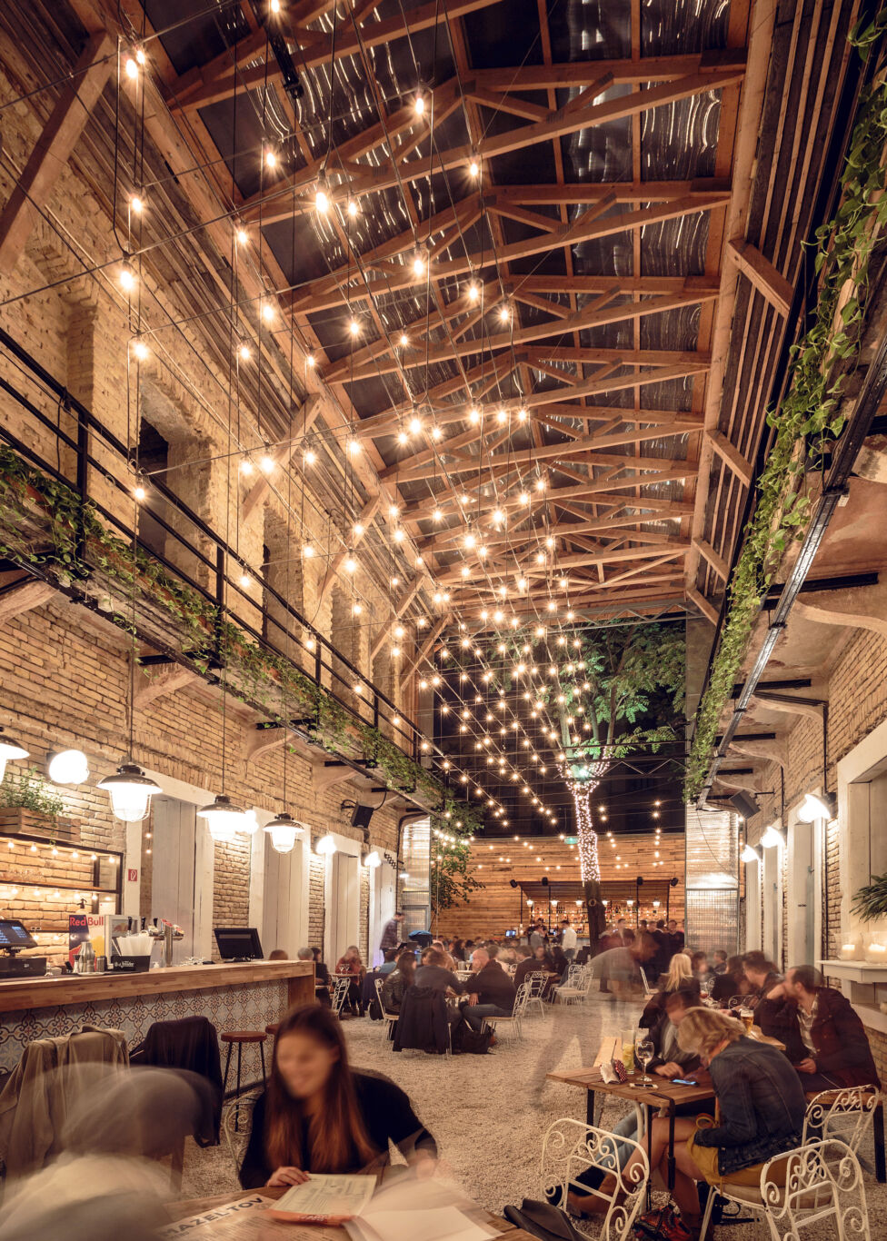 The beautiful string-lit courtyard interior of Mazel Tov