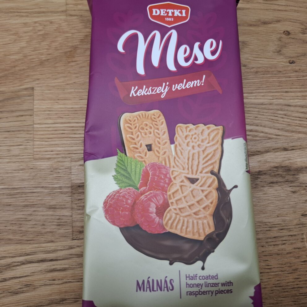 Square Mese Keksz cookies featuring spicy gingerbread dipped halfway in dark chocolate