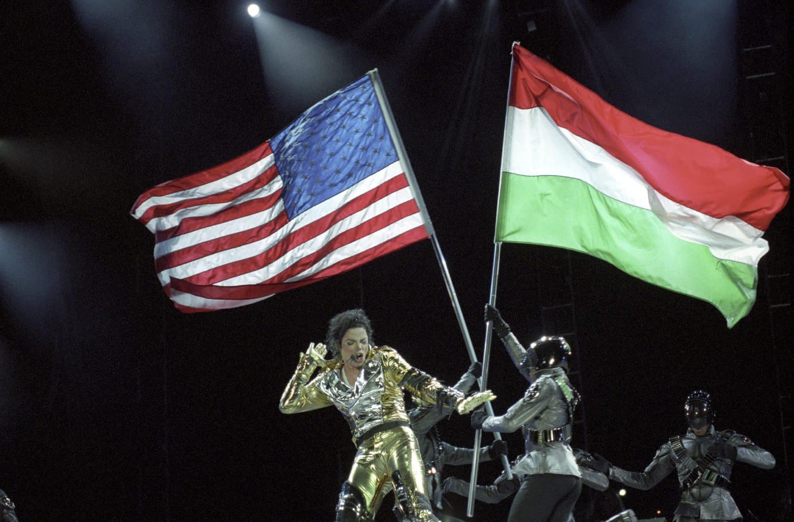 A historic archival photo of Michael Jackson greeting thousands of passionate fans during his 1996 visit to Budapest