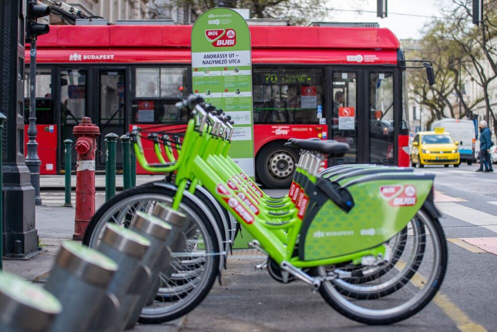 A row of green MOL Bubi bicycles lined up at a public docking station