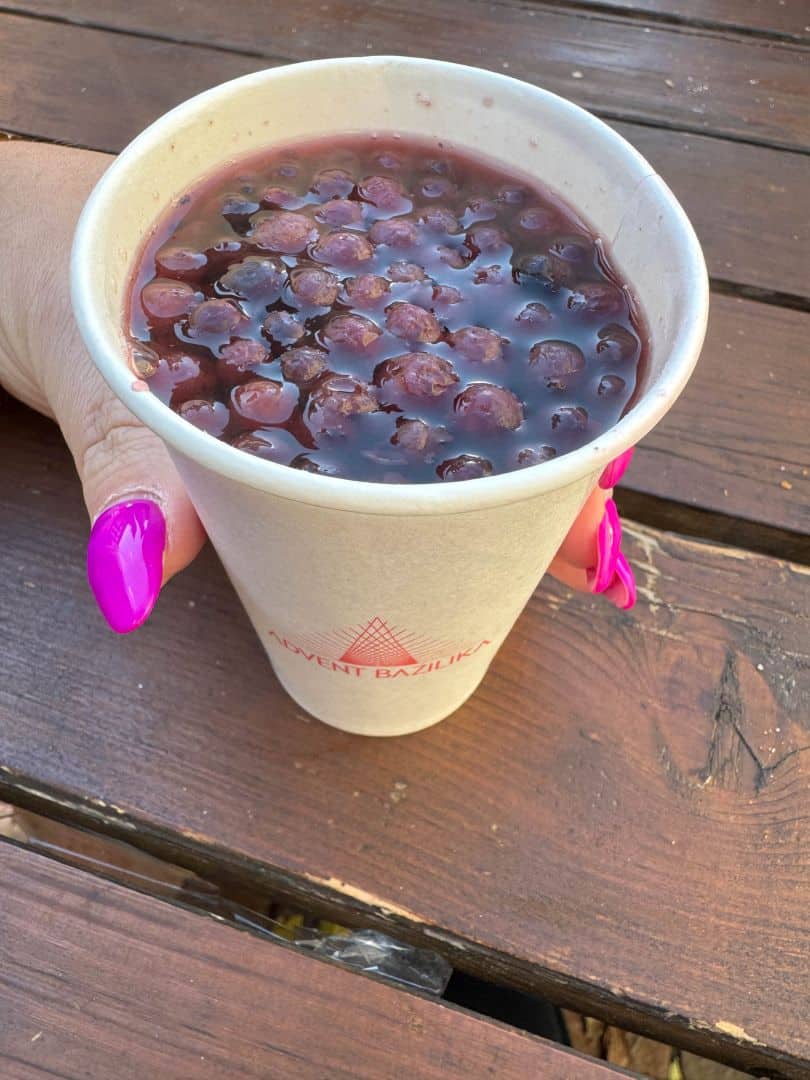 A mug of hot mulled wine garnished with an orange slice