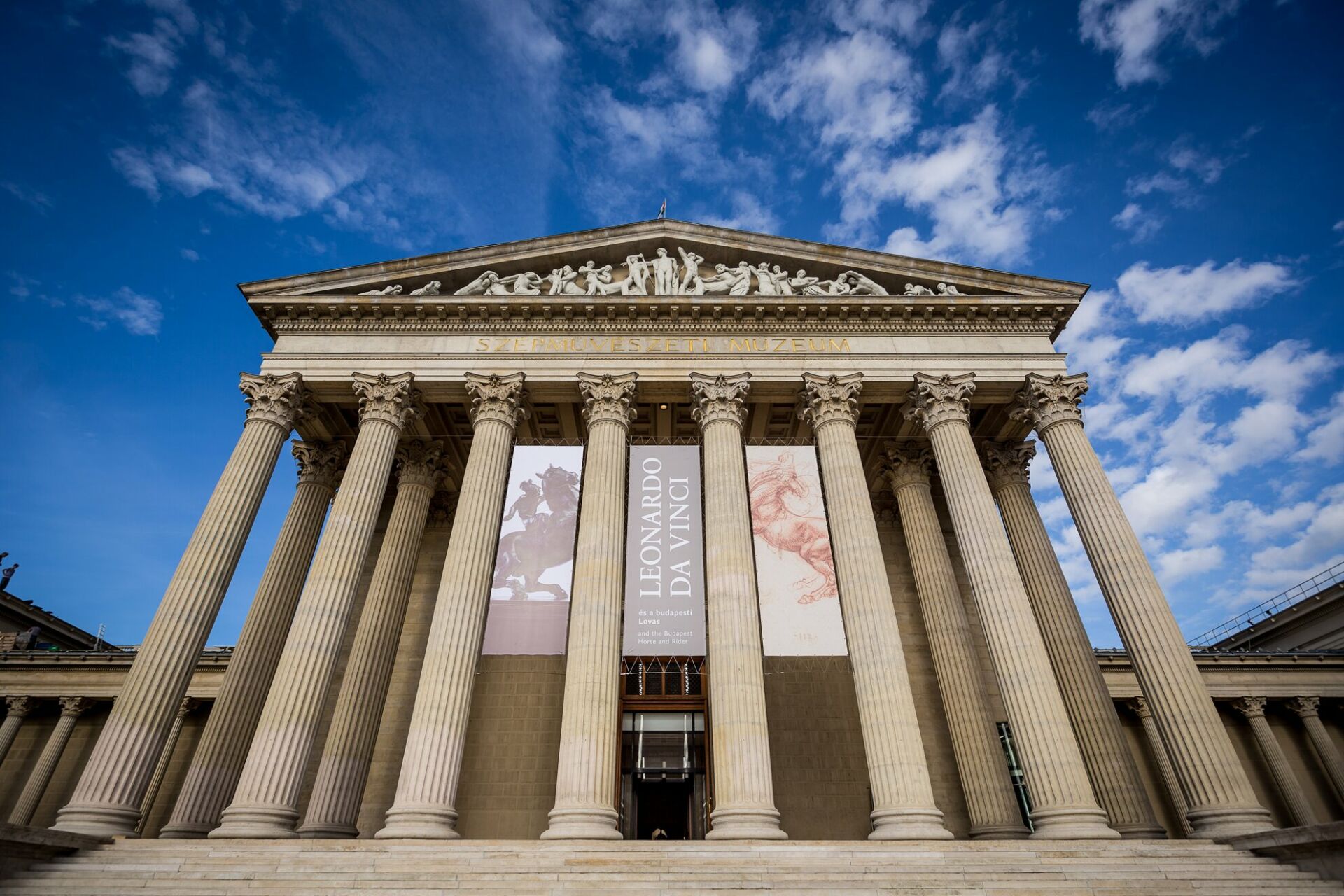 The Museum of Fine Arts prominently featuring massive hanging canvas banners advertising a special Leonardo Da Vinci exhibition