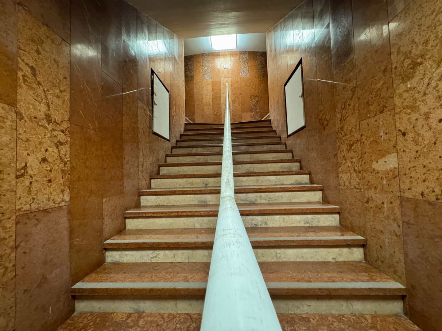 The heavily dramatic, red-carpeted grand stone staircase inside the National Gallery