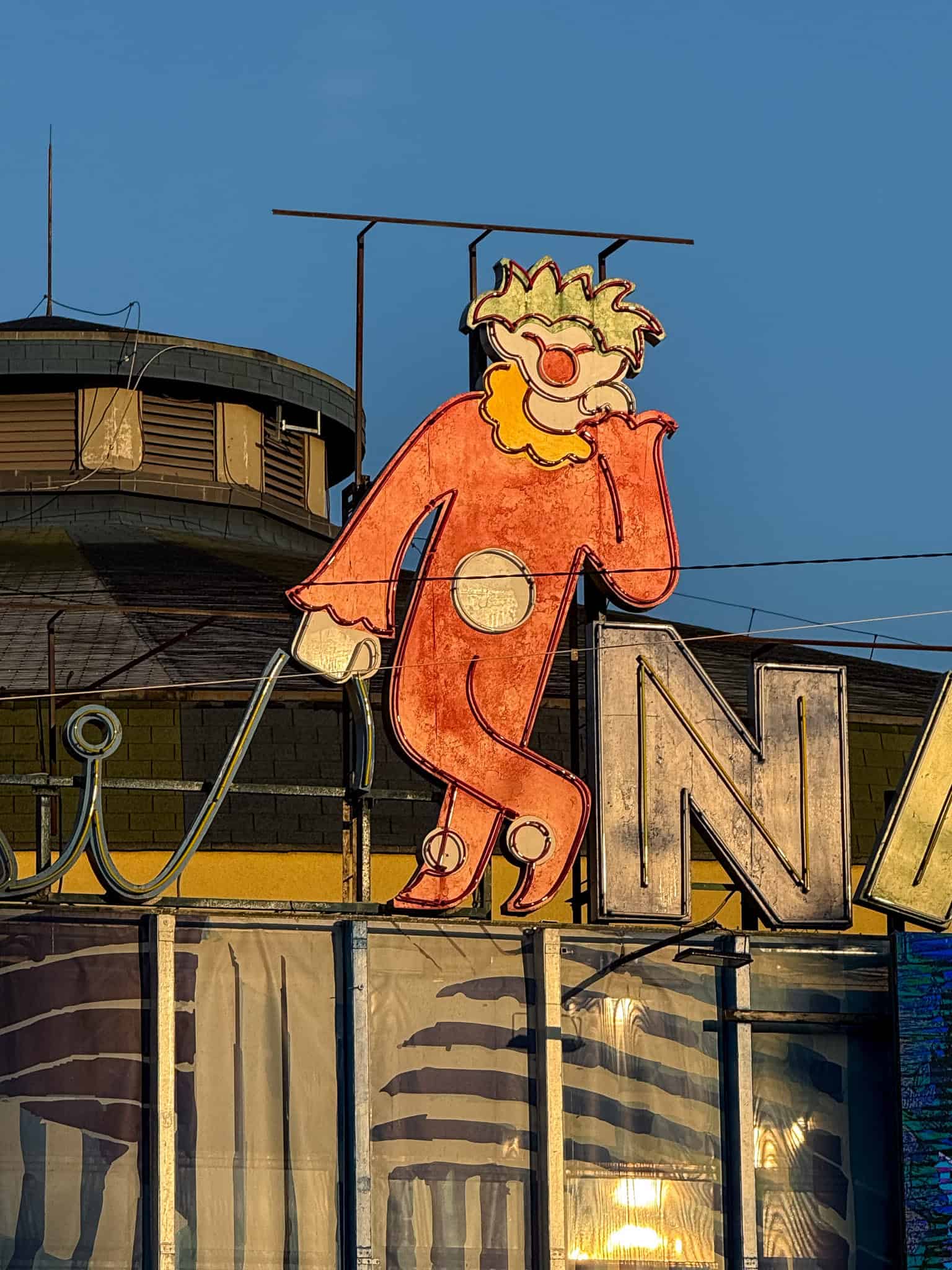Neon clown on the roof of the circus