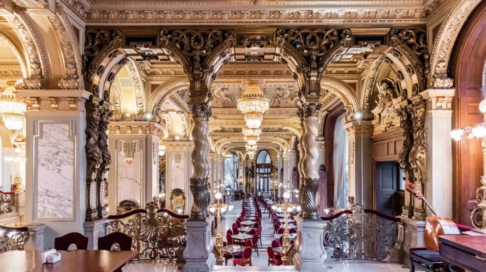 The grandiose golden interior of the iconic New York Cafe in Budapest