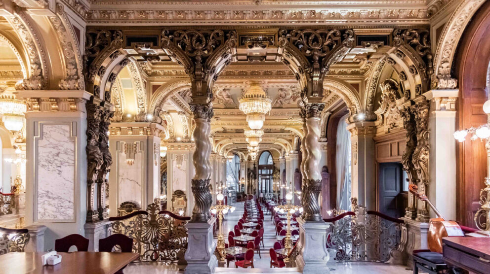 The grandiose walls and gilded pillars of the iconic New York Café in Budapest
