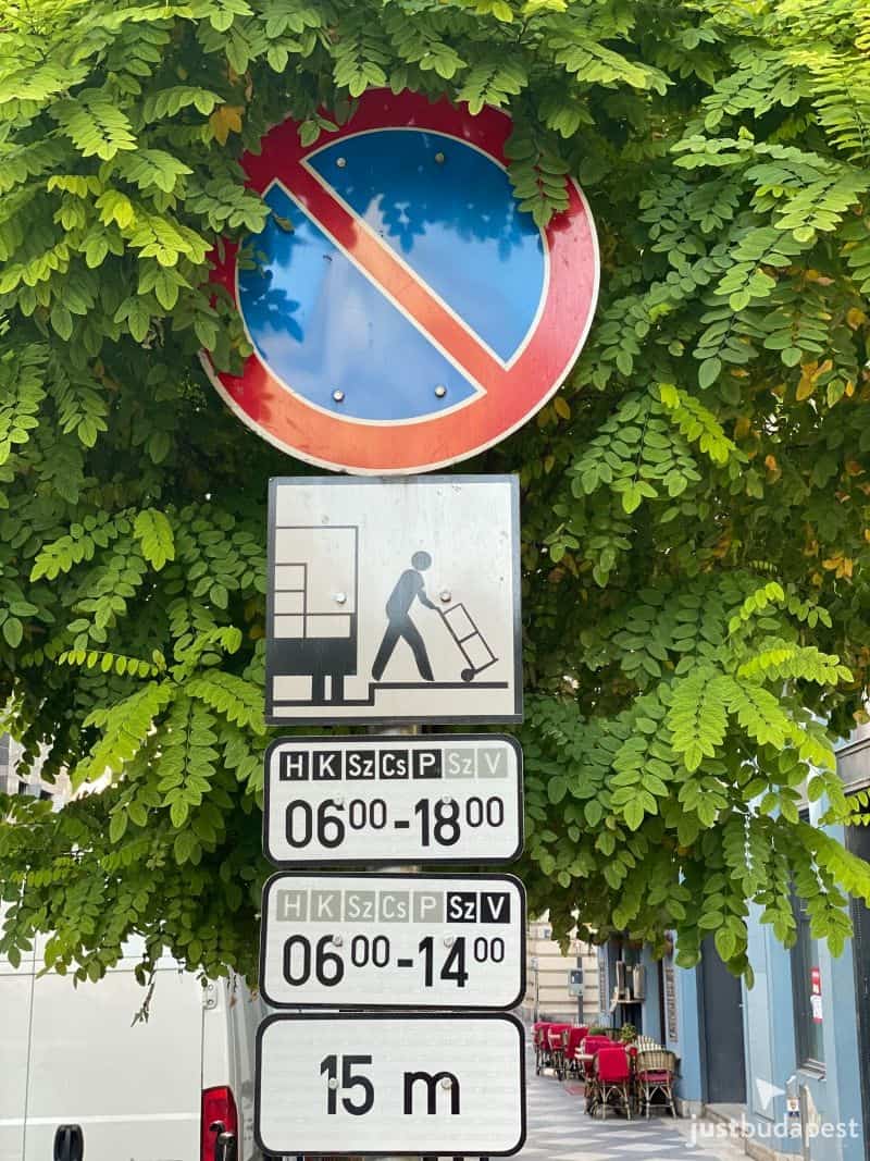 A street sign showing a No Parking symbol and supplementary signs indicating a loading zone