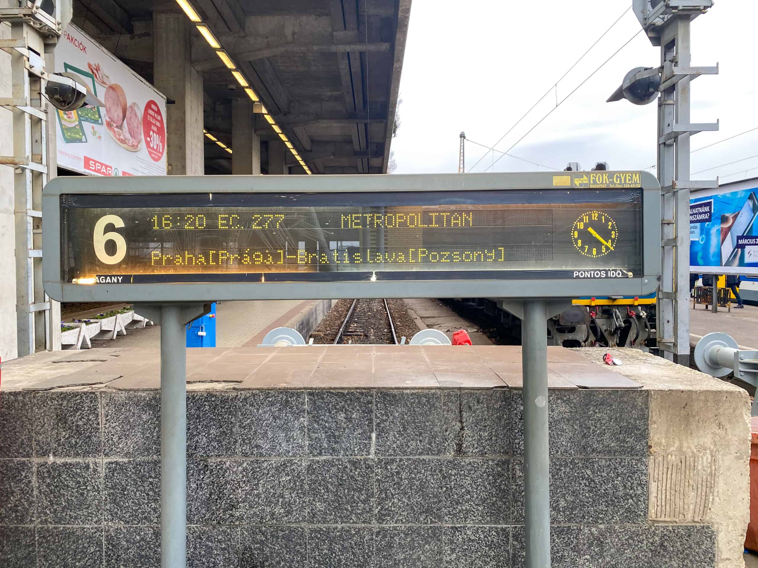 The large digital train departure board hanging inside Budapest Nyugati Railway Station