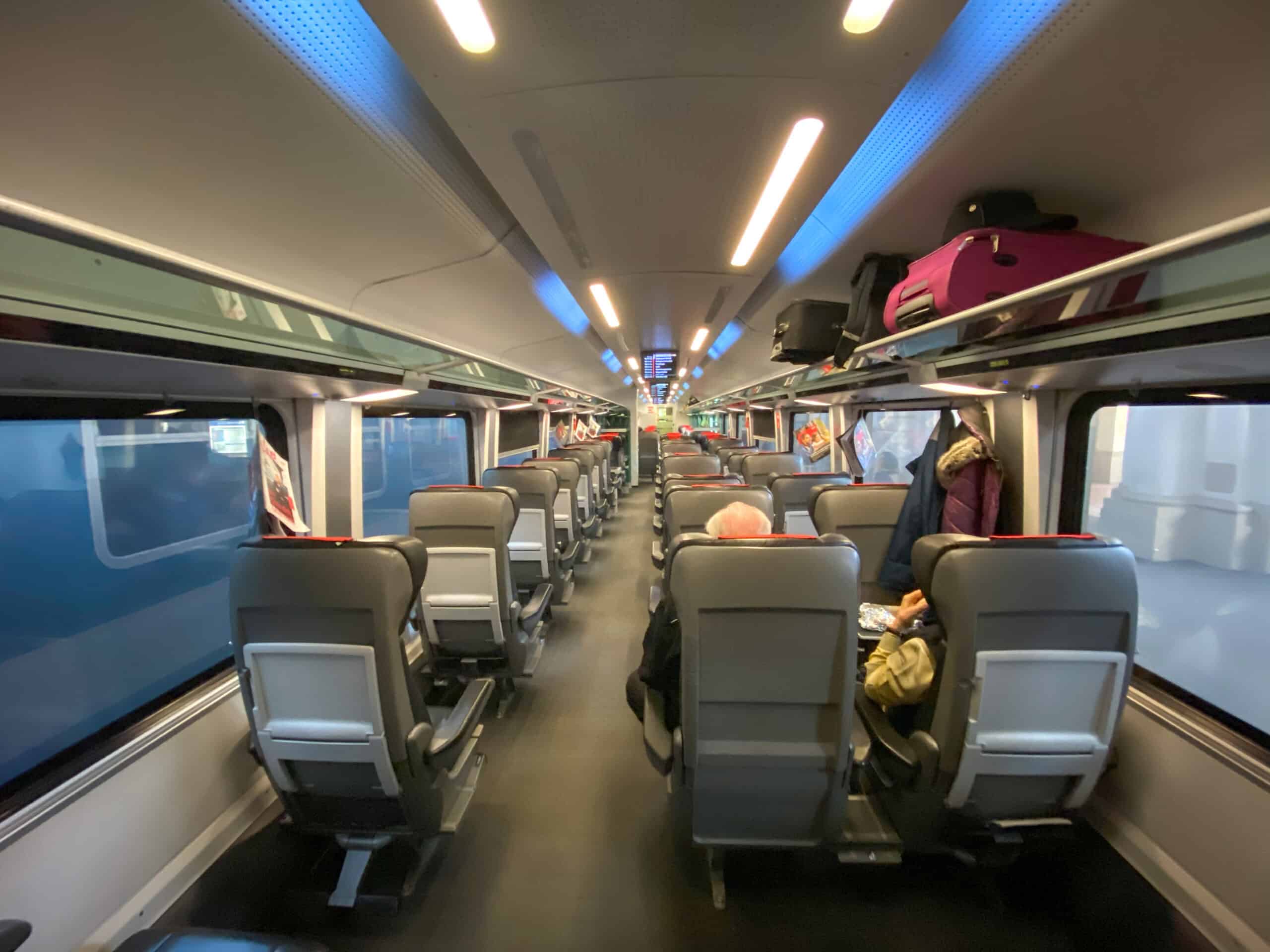 The interior of an ÖBB Railjet carriage with passengers and luggage