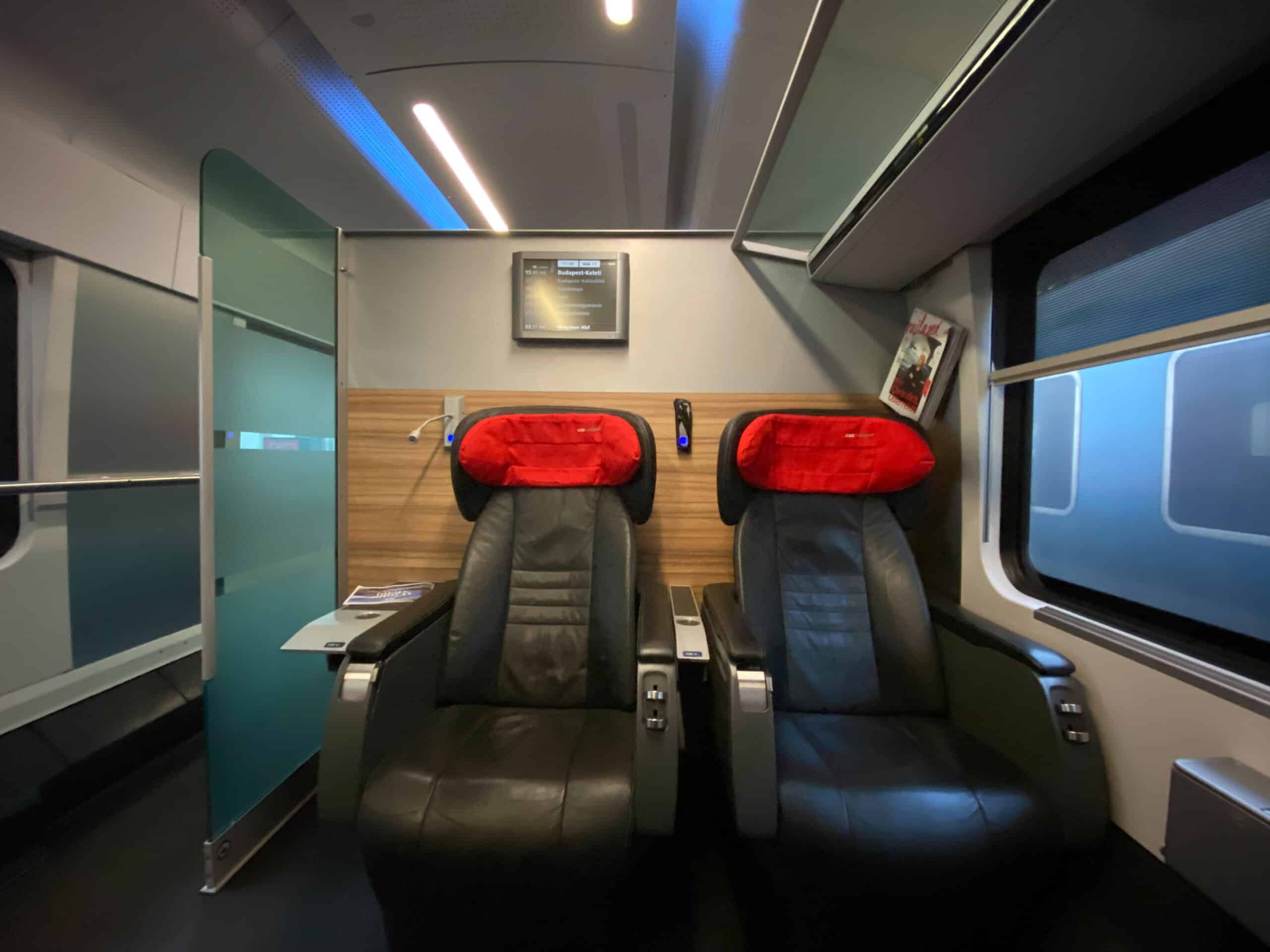 The exterior sliding doors of an ÖBB Railjet train at the station