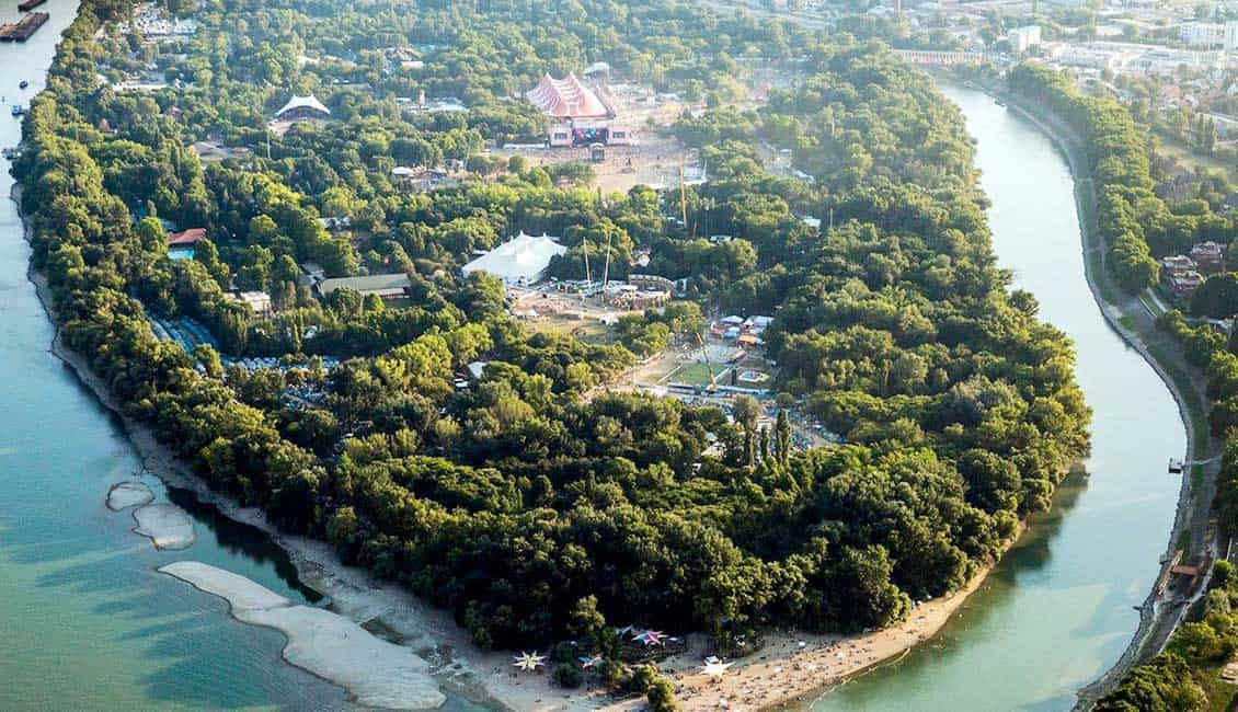 Aerial view of the green Obuda Island (Sziget Festival venue) surrounded by the Danube