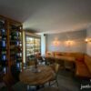 Guests sitting next to a massive shelf of wine in Palack Wine Bar