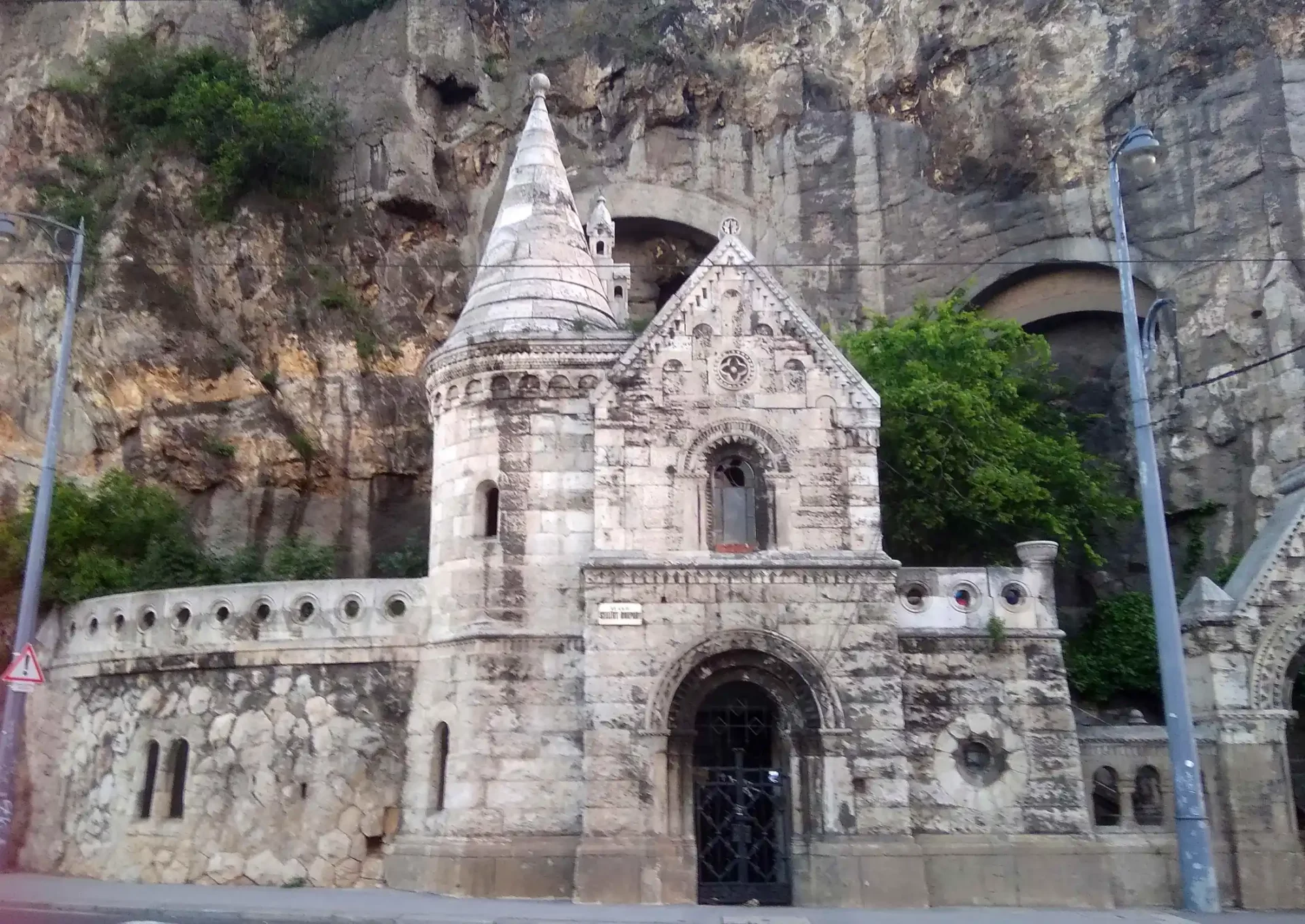 The dramatic rock facade and statue at the entrance of the Cave Church