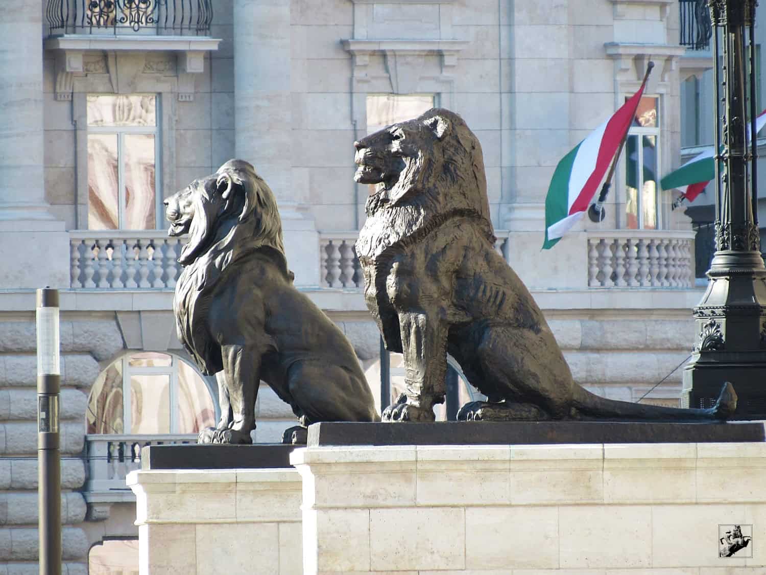 A stoic stone lion guarding the main entrance of the Hungarian Parliament