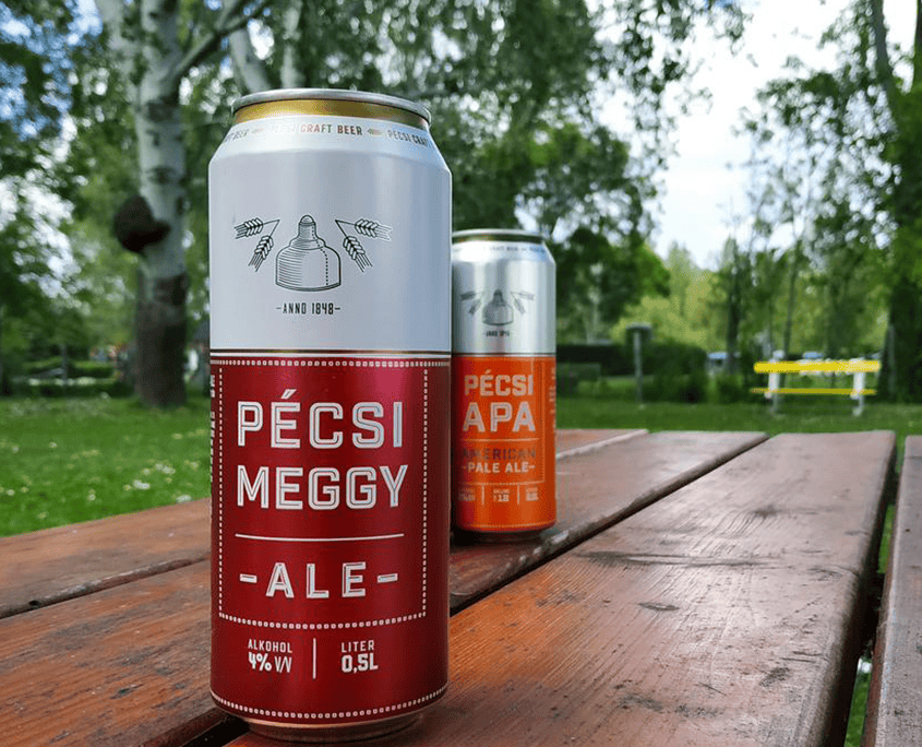 A green glass bottle of Pécsi Sör Premium Lager