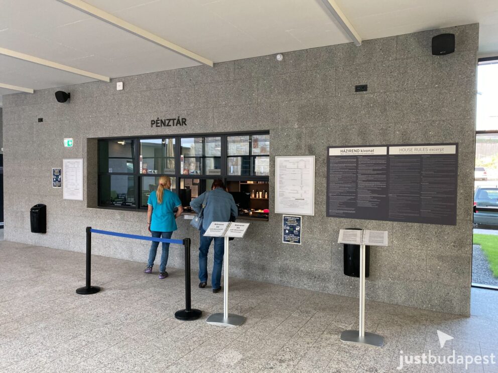 The main ticket counter and cashier desk inside the modern bath lobby