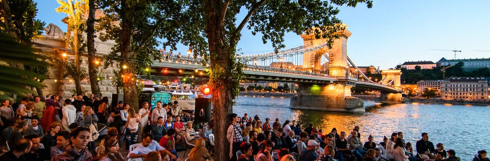 The lively Pontoon bar on the Danube riverbank at dusk in Budapest