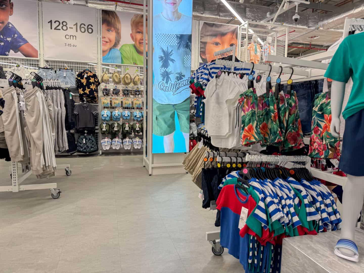 Racks of colorful shorts and t-shirts in the boys' clothing section