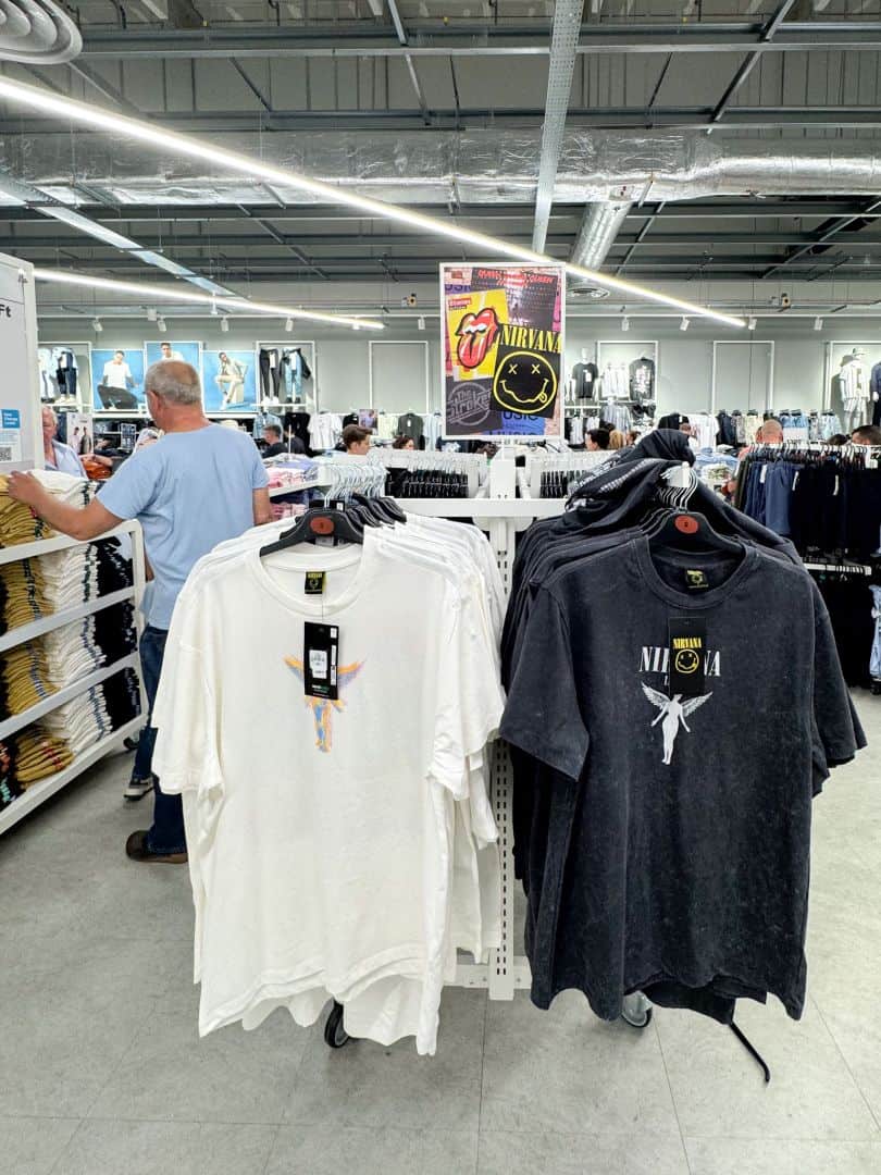 A display rack showing Nirvana band graphic t-shirts at Primark
