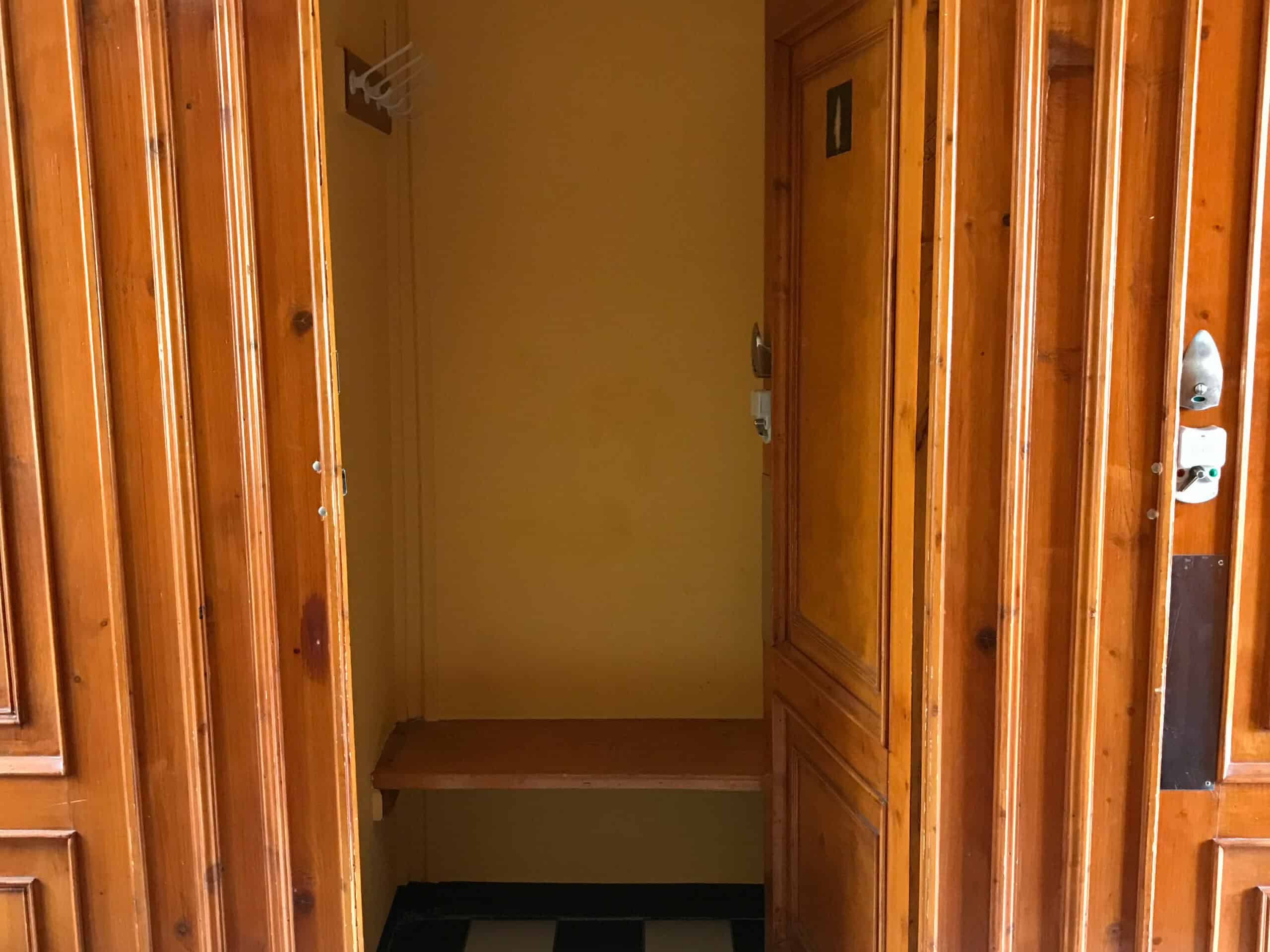 The vintage wooden interior of a private changing cabin at the Széchenyi Baths