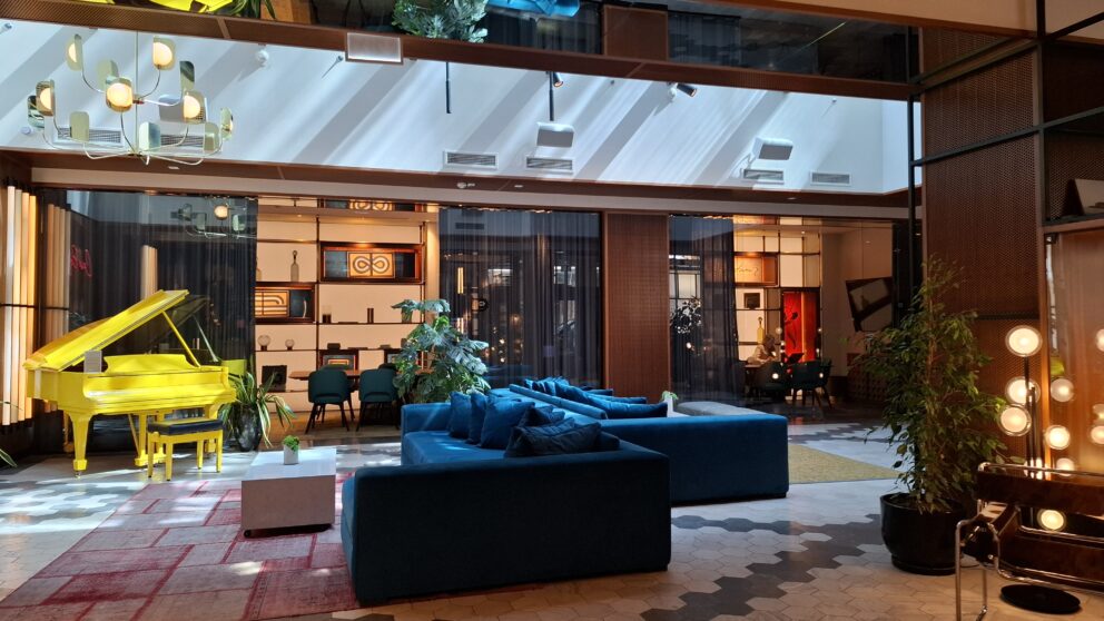 The spacious sunlit lobby of the Pullman Budapest Hotel