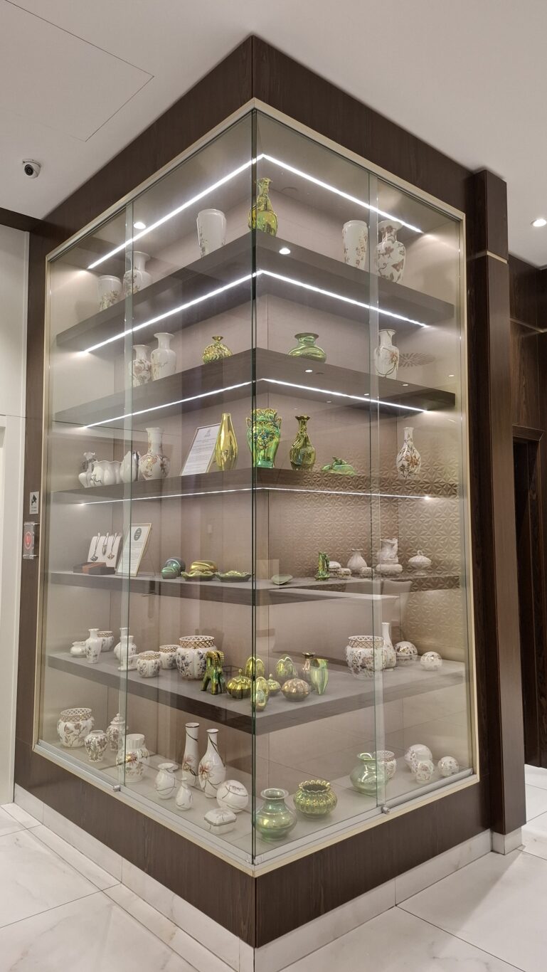 An illuminated glass cabinet filled with premium Herend porcelain pieces in the hotel