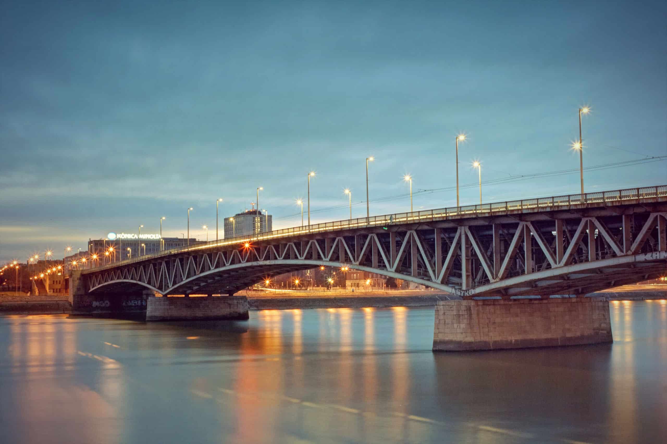The modern Rákóczi Bridge illuminated with its distinct red lights at night
