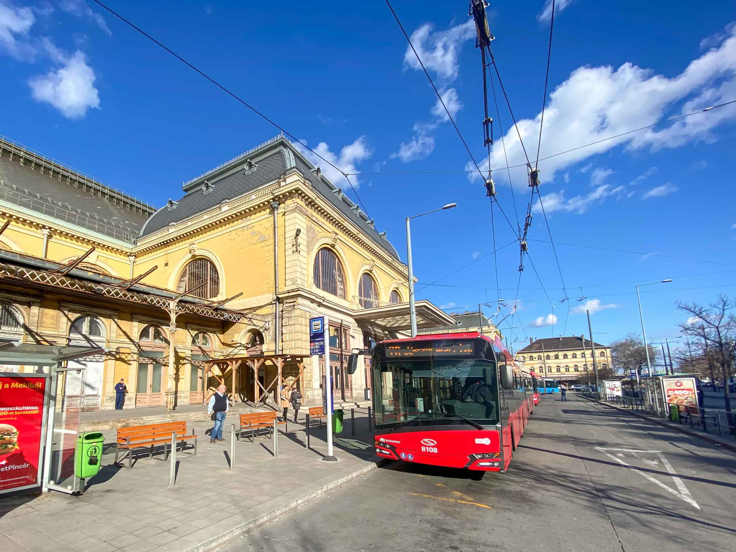 A red trolleybus parked near Keleti station