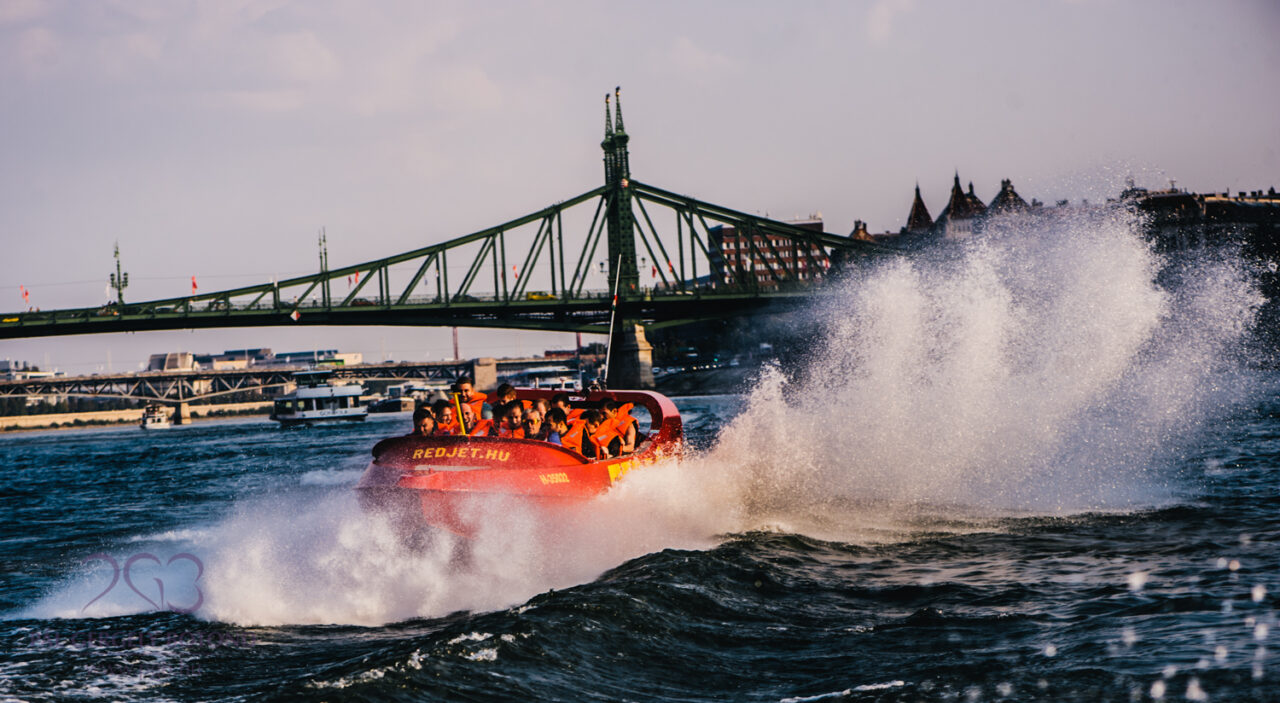 RedJet extreme speedboat with the Liberty Bridge in the background in Budapest