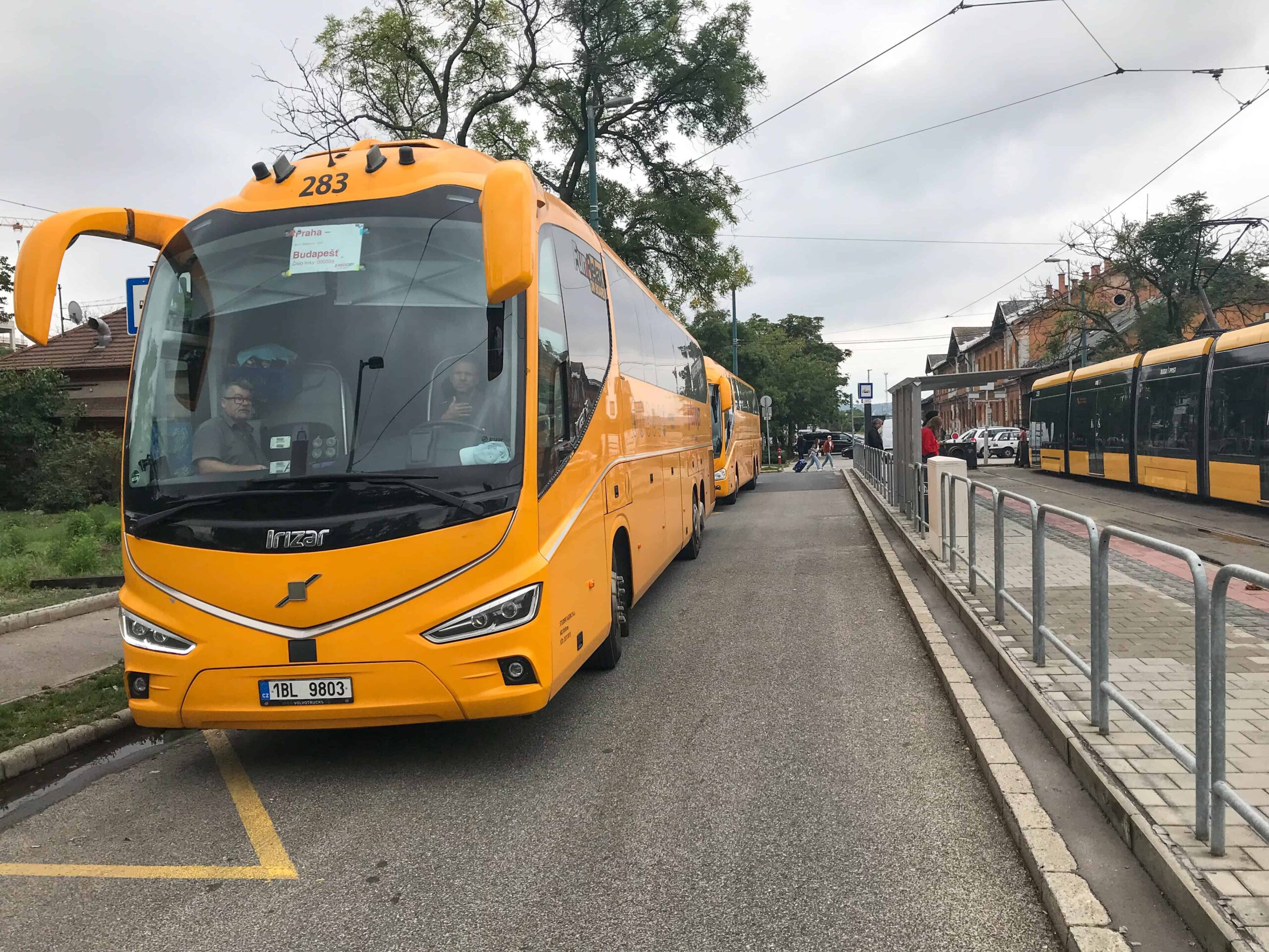 The bright yellow RegioJet bus stop sign located at the Kelenföld terminal