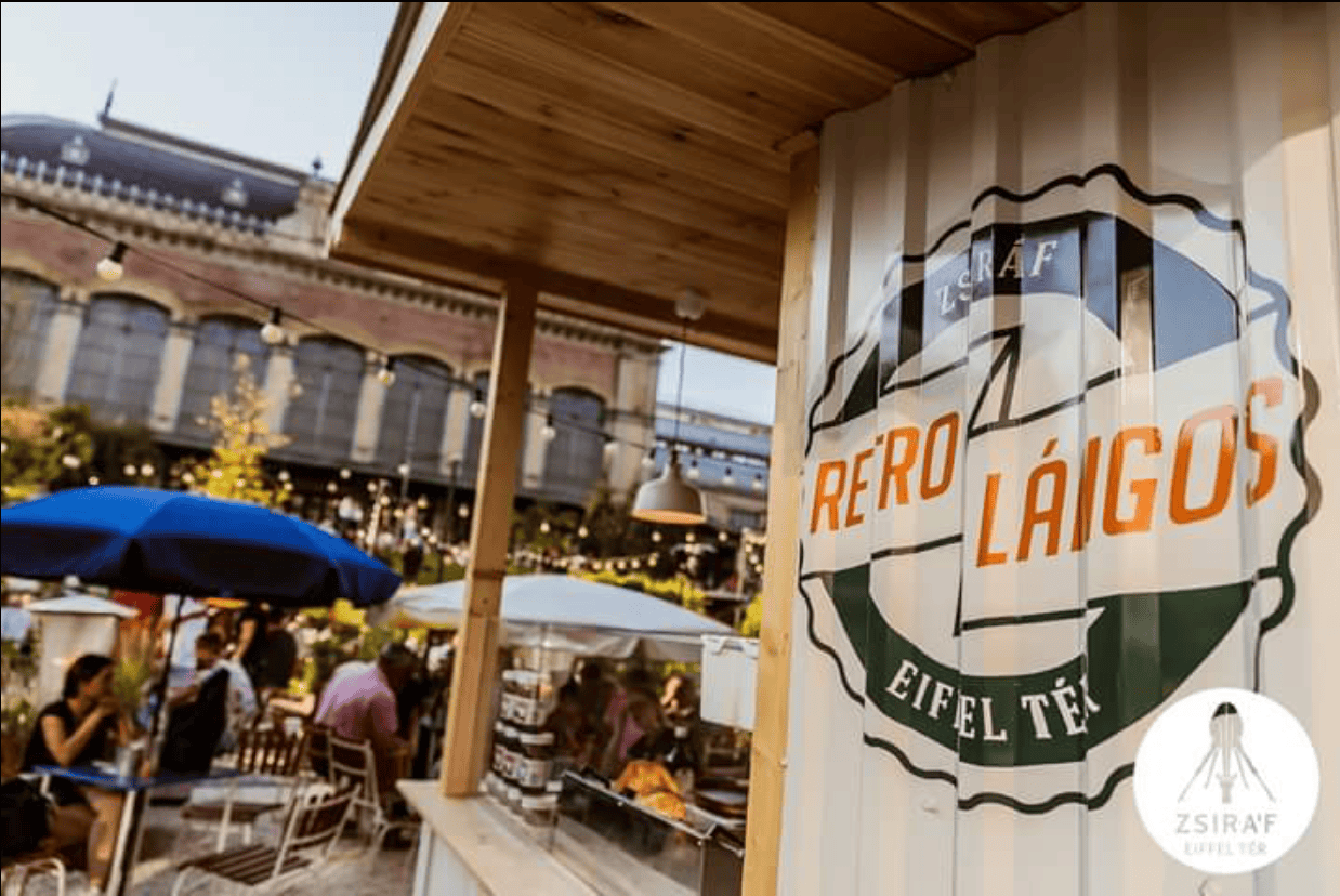 A classic, unassuming small outdoor retro lángos stall with a simple ordering window