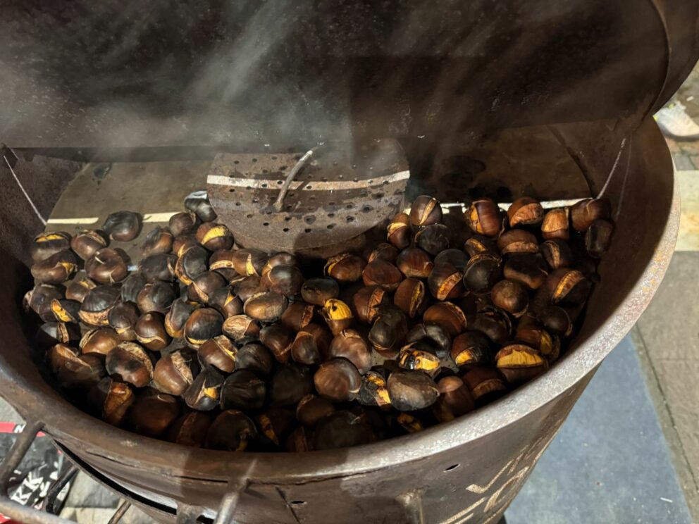A cone of freshly roasted chestnuts from the market